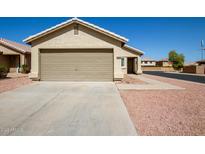 Charming single-story home featuring a two-car garage and low maintenance desert landscaping at 12240 W Scotts Dr, El Mirage, AZ 85335
