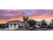 Charming single-story home with a landscaped front yard and a two-car garage at dusk at 12839 W Rincon Ct, Sun City West, AZ 85375
