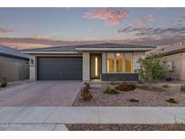 Charming single-story home featuring a two-car garage, low maintenance desert landscaping, and a welcoming front entrance at 14372 W Aster Dr, Surprise, AZ 85379