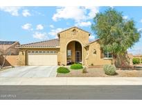 Charming single-story home with a well-manicured front yard and a two-car garage, complemented by a beautiful blue sky at 18438 W Brookwood Dr, Goodyear, AZ 85338