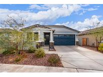 Charming single-story home featuring a blue garage door, stone accents, and well-maintained landscaping at 21105 N Blue Agave Dr, Maricopa, AZ 85138