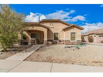 Charming single-story home with a well-maintained landscape, stone accents, and covered porch at 21752 E Domingo Rd, Queen Creek, AZ 85142