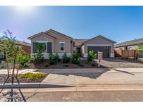 Charming single-story home with desert landscaping, a two-car garage, and a tile roof at 24134 N 172Nd Ave, Surprise, AZ 85387