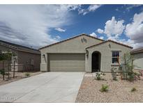 Charming single-story home featuring a neutral stucco facade, a two-car garage, and desert landscaping at 2514 E Music Mountain Ave, Apache Junction, AZ 85119
