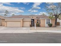 Charming single-story home with a three-car garage and desert landscaping at 3052 S Wesley --, Mesa, AZ 85212