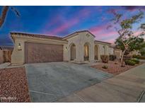 Charming single-story home featuring a two-car garage, arched entryway, and well-maintained desert landscaping at 3690 E Blue Spruce Ln, Gilbert, AZ 85298