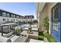 Relaxing balcony with plush seating overlooking the community pool and charming townhome architecture at 4438 N 27Th St # 27, Phoenix, AZ 85016