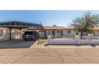 Charming single-story home with a covered carport and quaint, low-walled front yard at 4521 W Clarendon Ave, Phoenix, AZ 85031