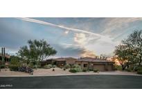 Stunning desert home boasting a three-car garage and beautifully xeriscaped front yard at 7013 E Summit Trail Cir, Mesa, AZ 85207