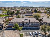 Aerial view showcasing the layout of the community with homes, mature trees, landscaping, and parking areas at 705 W Queen Creek Rd # 1201, Chandler, AZ 85248