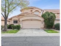 Charming two-story home featuring a two-car garage, well-maintained landscaping, and a classic tile roof at 7931 W Shaw Butte Dr, Peoria, AZ 85345