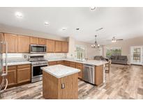 Well-equipped kitchen with stainless steel appliances, granite counters, and a center island at 11023 W Utopia Rd, Peoria, AZ 85373