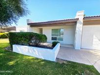 Inviting single-story home featuring lush landscaping, well-maintained lawn, and convenient attached garage at 11221 N 32Nd St, Phoenix, AZ 85028