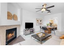 Inviting living room features a cozy fireplace, and sleek modern decor at 11515 N 91St St # 142, Scottsdale, AZ 85260