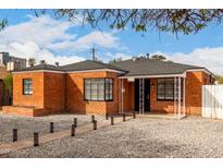 Charming brick home with well-manicured landscaping and a welcoming front entrance at 1810 N 12Th St, Phoenix, AZ 85006