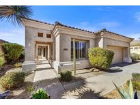 Charming single-story home featuring a desert-style landscape, stucco facade, and a tiled roof in a sunny, inviting setting at 26560 N 115Th St, Scottsdale, AZ 85255