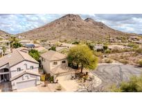 A beige two-story home featuring a well-manicured yard and a mountain view in the background at 26815 N 65Th Ave, Phoenix, AZ 85083