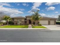 Beautiful single-story home featuring stone accents, a three car garage, and professionally landscaped front yard at 3425 E Birchwood Pl, Chandler, AZ 85249