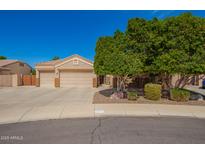 Charming single-Gathering home featuring a three-car garage, desert landscaping, and mature shade tree at 3562 E Harvard Ct, Gilbert, AZ 85234