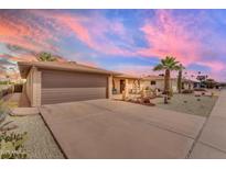 Inviting front exterior with desert landscaping, private front porch, and two-car garage at 4720 E Flossmoor Cir, Mesa, AZ 85206