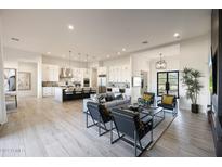 Spacious living room with modern decor, sleek furniture, and an open floor plan into the kitchen at 510 E Woburn Ln, Phoenix, AZ 85085