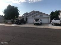 Charming single-story home featuring a two-car garage and well-maintained front yard at 5423 W Topeka Dr, Glendale, AZ 85308