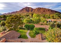 Breathtaking aerial view of a house surrounded by lush landscaping with a mountain backdrop under a beautiful sky at 5801 E Exeter Blvd, Phoenix, AZ 85018