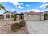 Charming single-story home with a well-manicured desert landscape and a two-car garage at 70 S Laura Ln, Casa Grande, AZ 85194