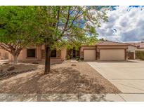 Charming single-story home featuring a three-car garage and low-maintenance desert landscaping at 7339 W Monte Lindo Ln, Glendale, AZ 85310