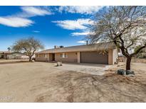 Ranch-style home with neutral paint, a two-car garage, and a desert landscape at 8431 W Planada Ln, Peoria, AZ 85383