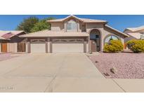 Charming home with a three-car garage, neutral paint, and low-maintenance landscaping at 9116 W Acoma Dr, Peoria, AZ 85381