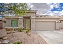 Charming single-story home with a two-car garage and desert landscaping at 137 E Rock Wren Dr, San Tan Valley, AZ 85143