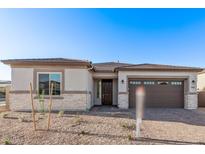 Charming single-story home featuring a stone facade, neutral paint, and a well-manicured front yard at 15846 W Bronco Trl, Surprise, AZ 85387