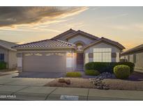 Charming single-story home with a well-maintained front yard and a two-car garage at sunset at 16424 N 1St Dr, Phoenix, AZ 85023