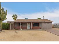 Charming single-story home with desert landscaping, brick accents, and covered porch at 16833 N 17Th Pl, Phoenix, AZ 85022