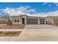 Charming single-story home with a three-car garage and stone accents at 17845 W Red Fox Rd, Surprise, AZ 85387