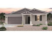 Charming single-story home with a two-car garage and desert landscaping in the front yard at 18035 W Camino De Oro --, Surprise, AZ 85387