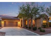 Charming single-Gathering home featuring a two-car garage and well-manicured landscaping at dusk at 21008 W Cora Vis, Buckeye, AZ 85396