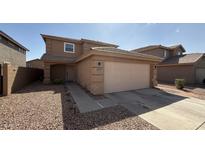 Charming two-story home features a spacious two-car garage and low-maintenance landscaping at 22461 W Woodlands Ave, Buckeye, AZ 85326