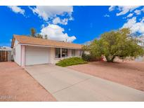 Charming single-story home featuring a well-maintained front yard and inviting curb appeal at 7302 W Cheryl Dr, Peoria, AZ 85345