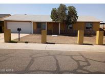 Charming single-story home featuring a well-manicured front yard and an attached garage at 8141 W Elm St, Phoenix, AZ 85033