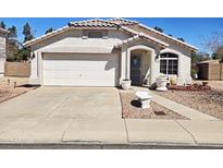 Charming single-story home with a well-maintained yard, two car garage and inviting front entrance at 10928 W Kaler Dr, Glendale, AZ 85307