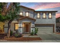 Inviting two-story home with a well-manicured front yard and a two-car garage at 11202 W Mckinley St, Avondale, AZ 85323