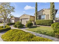 Beautiful single-Gathering home with manicured landscaping and a charming, well-maintained front yard at 16026 W Cortez St, Surprise, AZ 85379