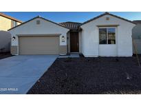 Charming single-story home with a two-car garage and desert landscaping in front at 17547 W Lupine Ave, Goodyear, AZ 85338