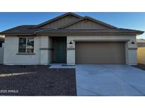 Charming single-Gathering home featuring a two-car garage and welcoming covered porch at 17553 W Lupine Ave, Goodyear, AZ 85338