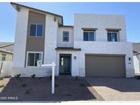 Beautiful two-story home with modern design, desert landscaping, and a two car garage at 18035 W Vogel Ave, Goodyear, AZ 85338