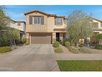 Charming two-story home with a well-manicured front yard, two-car garage and desert landscaping at 5431 S Canyon Rim --, Mesa, AZ 85212