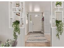 Inviting entryway with decorative shelving and a stylish rug welcomes you into this charming home at 641 N 61St Pl, Mesa, AZ 85205