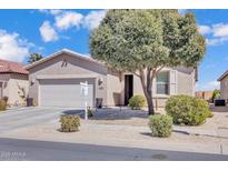 Charming single-story home featuring a two car garage, desert landscaping and a mature shade tree in the front yard at 10 N Agua Fria Ln, Casa Grande, AZ 85194